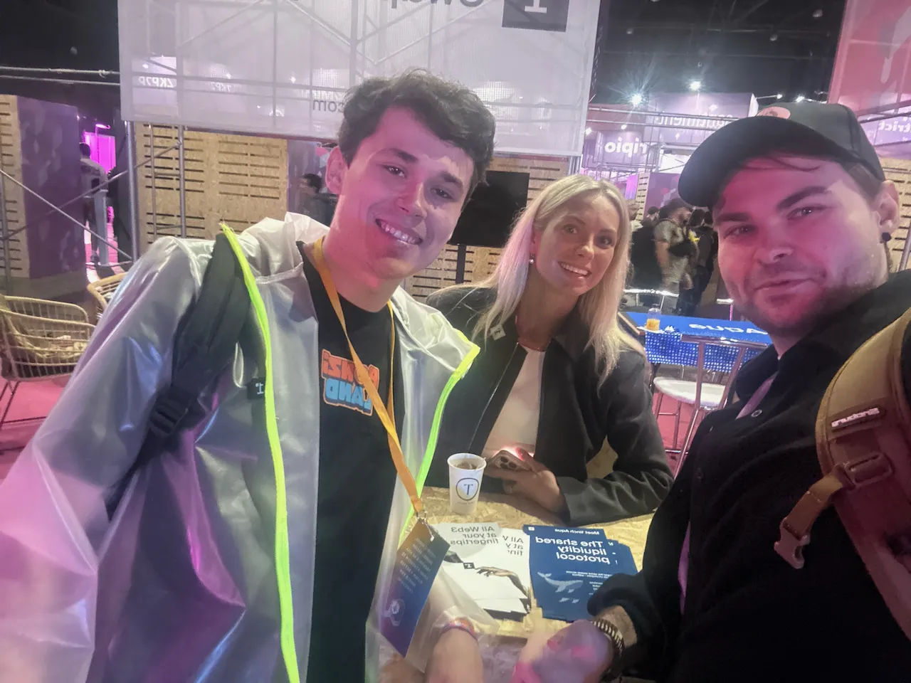 Selfie at the 1inch booth with Aqua flyers "The shared liquidity protocol" on the table