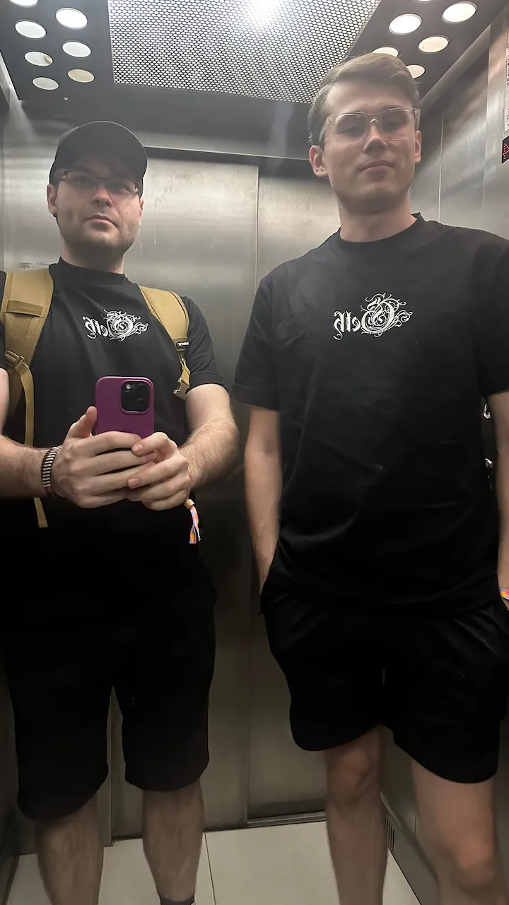 Two of us in the elevator wearing black Geth T-shirts
