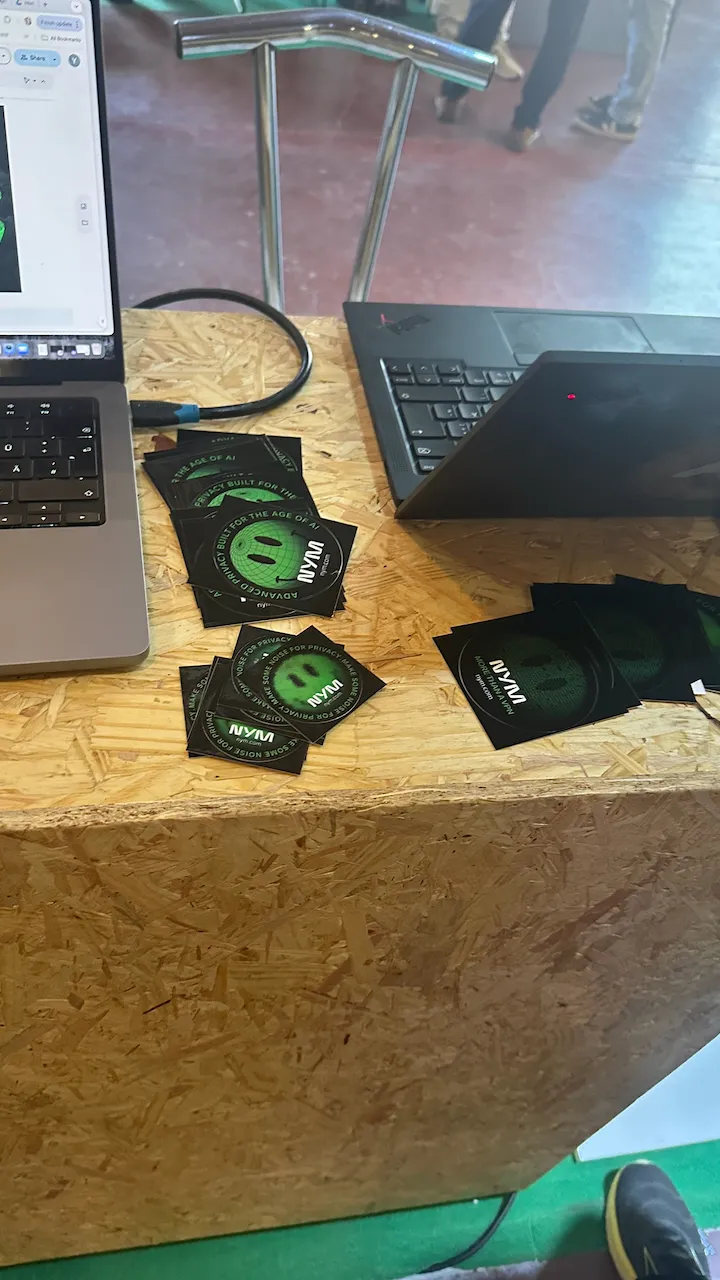 Nym stickers "Advanced privacy built for the age of AI" on the booth table